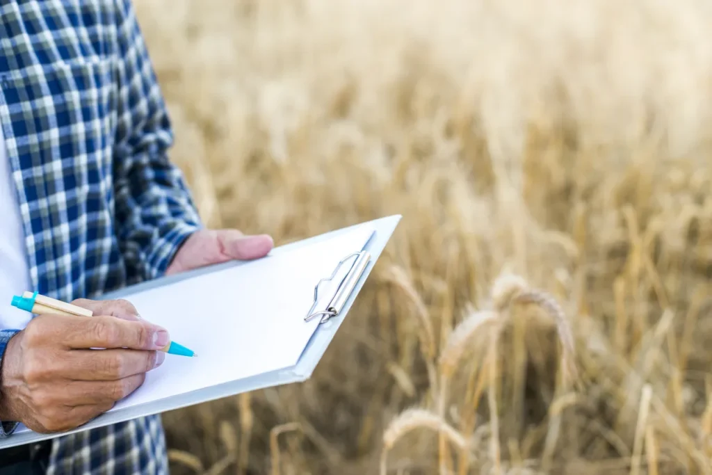 close up man taking notes clipboard